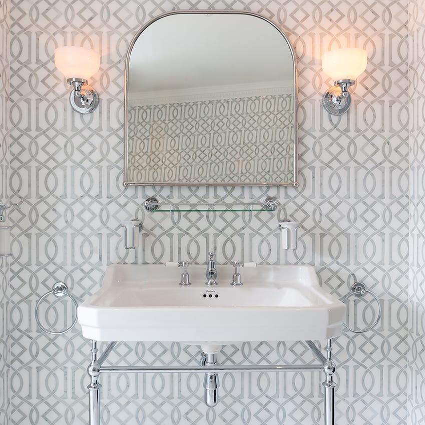 Traditional basin and washstand against inlaid wall