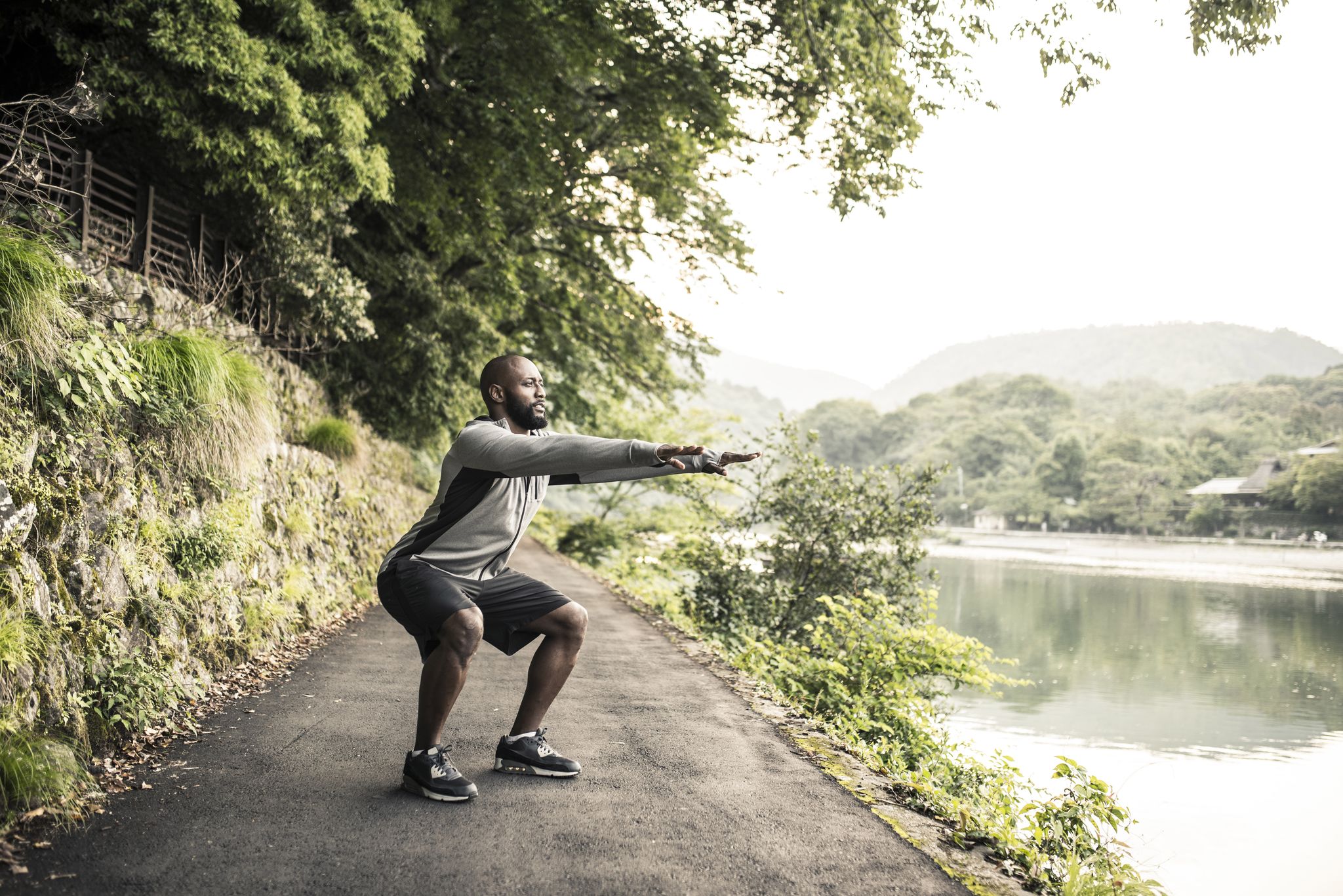 an african american adult man working out in nature