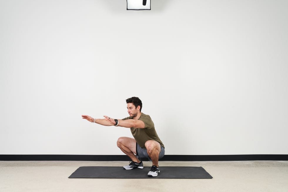 trainer ian finestein performing a series of squat exercises in may 2022