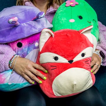 a person holding three squishmallows