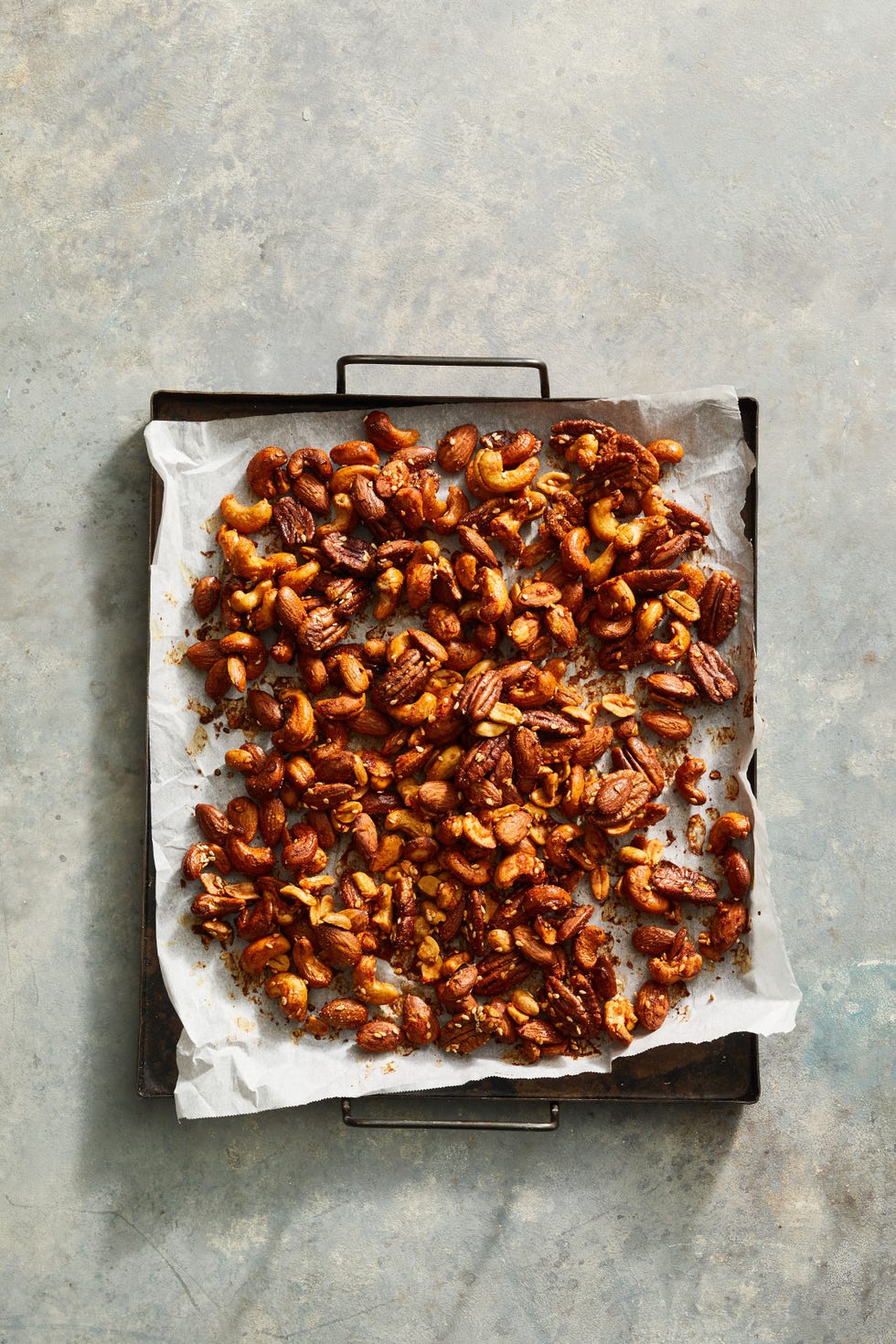 sriracha mixed nuts on parchment paper