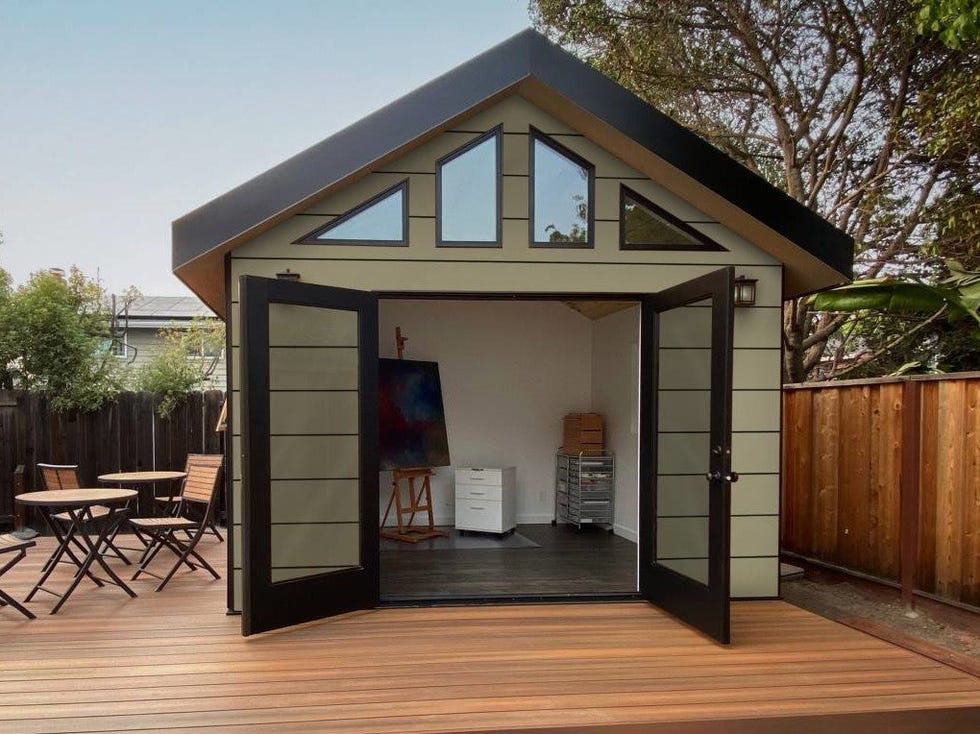 garden studio with large open doors and wooden deck