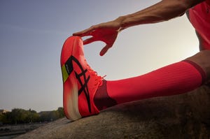 a person's hand holding a shoe