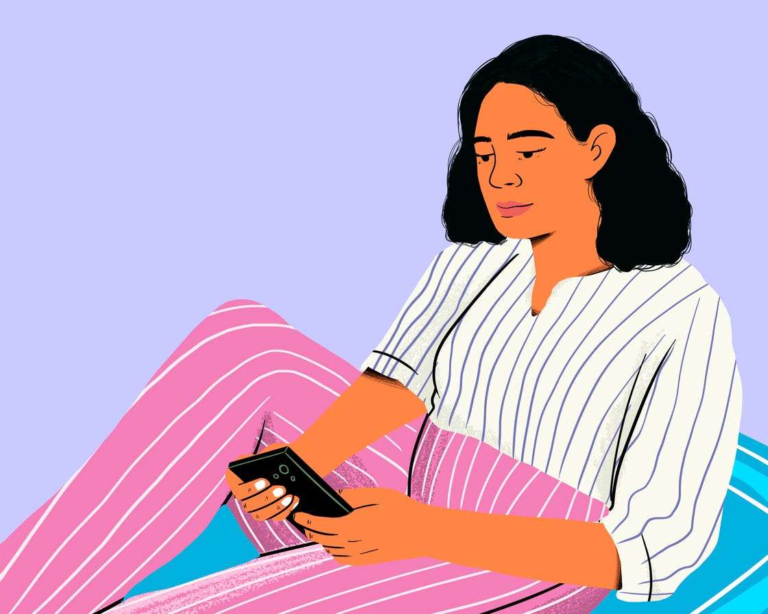 Person relaxing while using a smartphone wearing a striped shirt and patterned pants