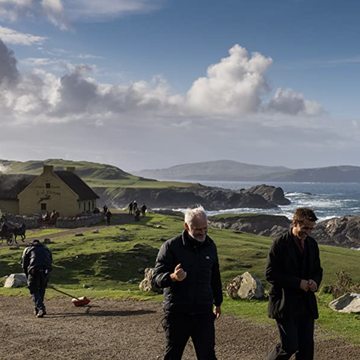 scene of two men walking along irish coast
