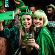 two friends with beers taking selfie on st patricks day
