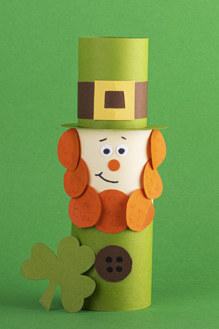 green cute leprechaun made of handmade paper on a green background, space for text cultural and religious holiday st patricks day