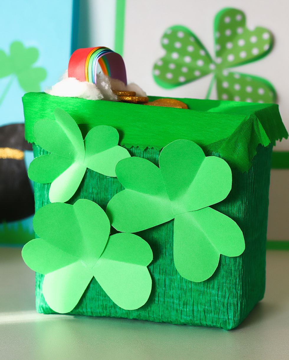 diy leprechaun trap with gold coins, rainbow and green ladder st patricks day background gift idea, decor saint patricks day step by step child kid craft process top view irish holiday