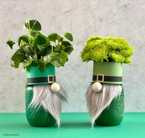 mason jars decorated like gnomes for a st patricks day craft with long beards, green top hats, filled with green flowers