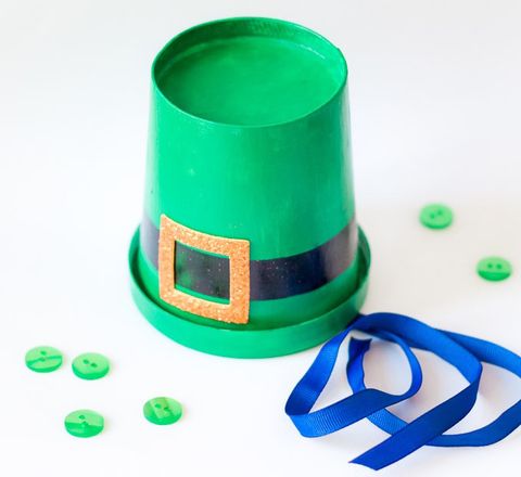 st patrick's day crafts, green mini leprechaun top hat with a blue ribbon on the side