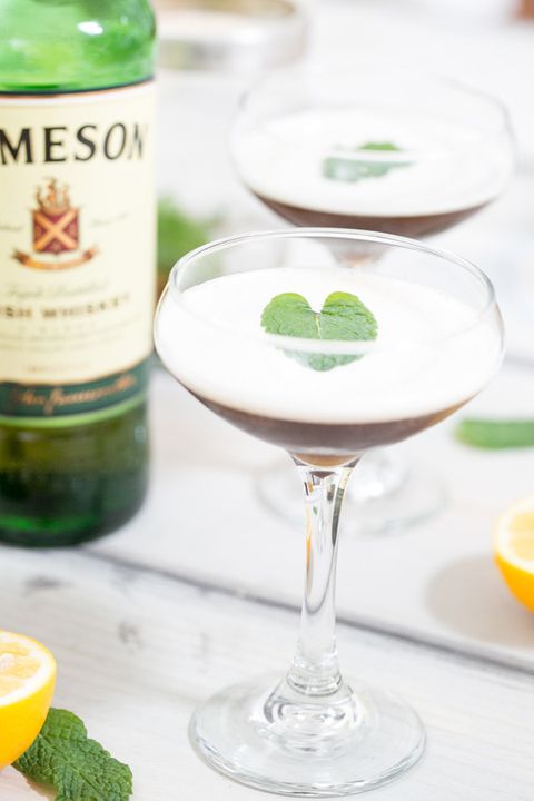whiskey cocktail in coupe glass with jameson bottle
