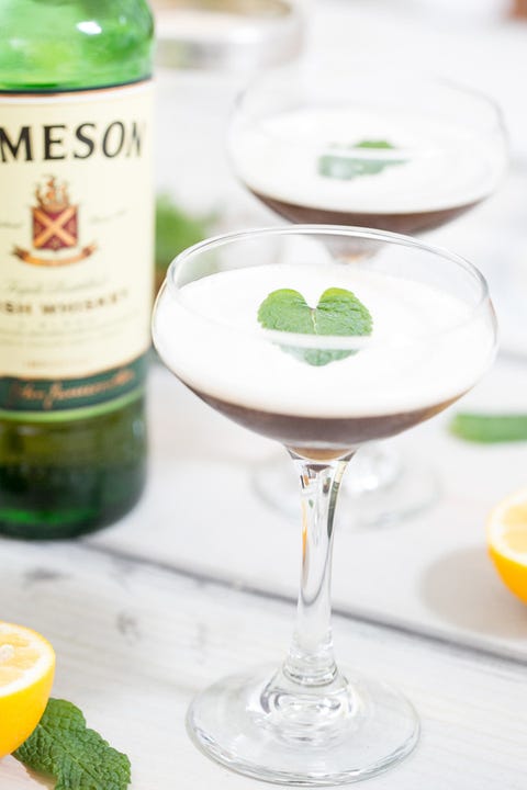 st patricks day drinks drunken Leprechaun whiskey cocktail in coupe glass with jameson bottle