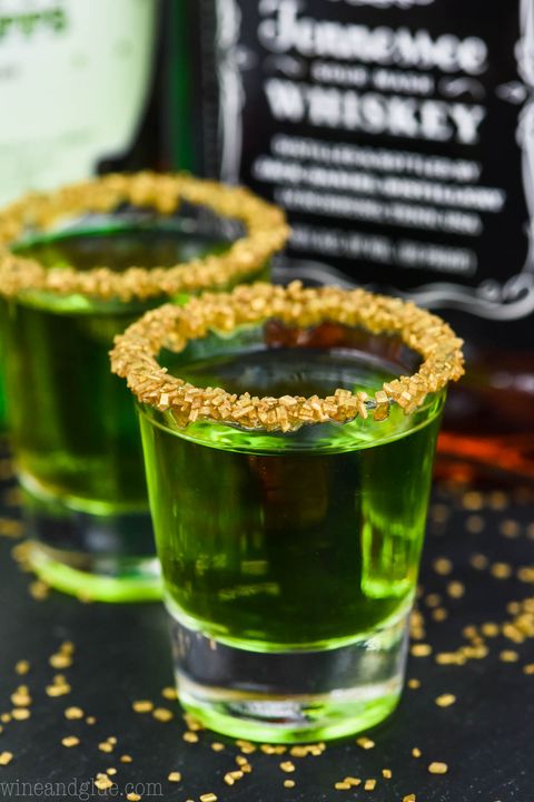 green drink in shot glass with gold sprinkles