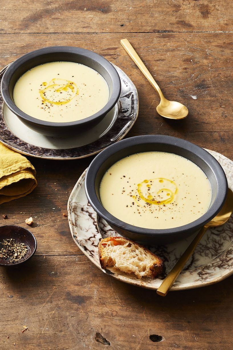 bowls of potato leek soup with a side of bread