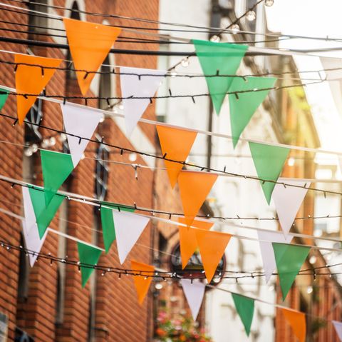 garland with irish flag colors in a street of dublin, ireland   saint patrick day celebration concept