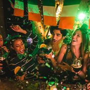 friends partying with drinks and confetti on saint patrick's day that could be captioned shenanigans squad on instagram