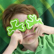 redhead and freckle face irish boy leprechaun with shamrock cookies over his eyes smiling irish child wearing green on st patricks see lightboxes below for more holdiday food and people backgrounds