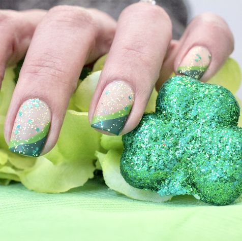a french manicure with green tips and glitter for st patricks day