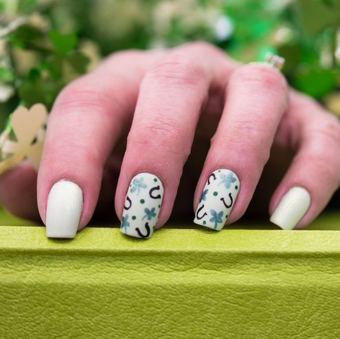 saint patricks day inspired nail art that has clovers and horseshoes