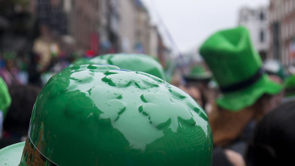 a crowd of green hats in the street during st patrick's day parade in dublin