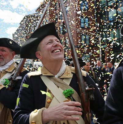 lexington minutemen smile as confetti falls during the boston st patricks day parade