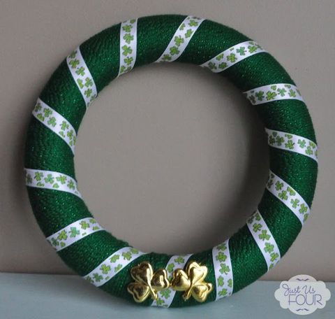 wreath wrapped with green yarn and ribbon with gold shamrocks