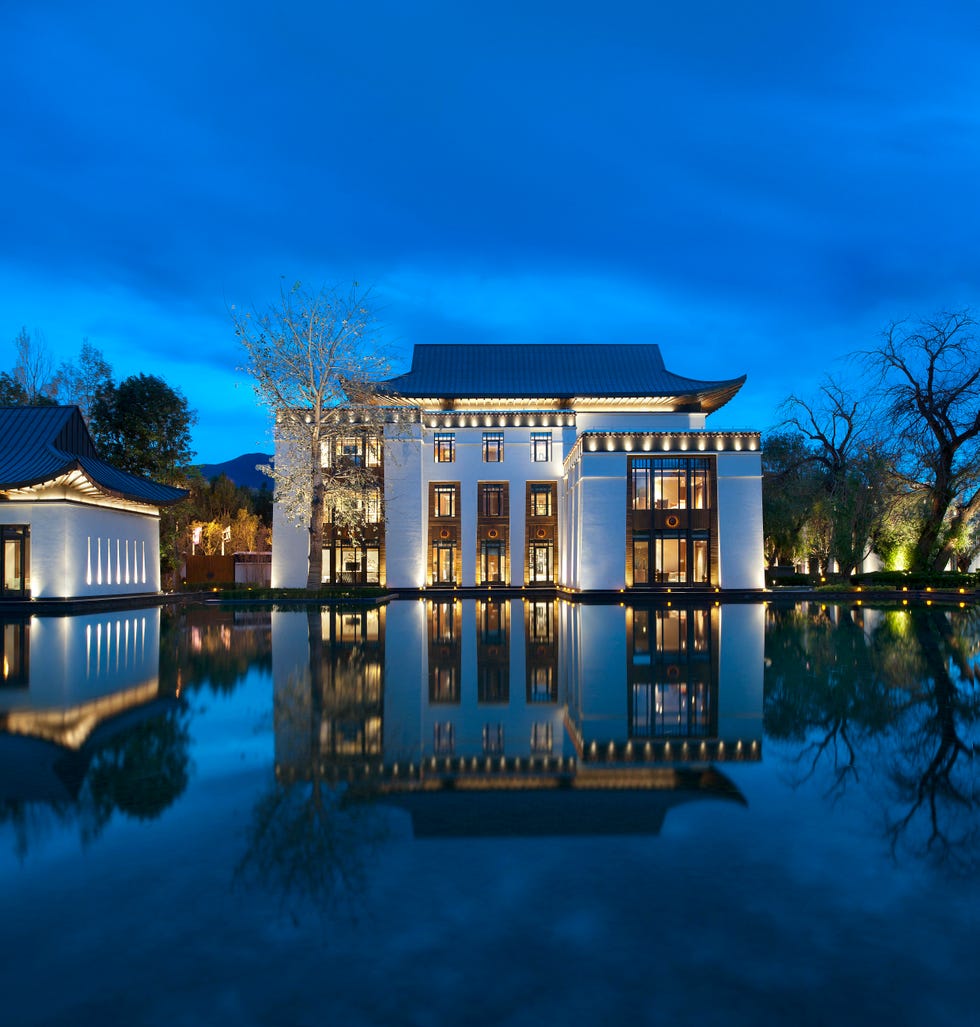 a house with a pool in front of it with hearst castle in the background