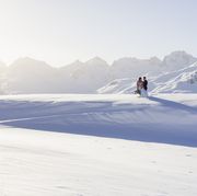 wedding couple shooting in the mountain of engadin in winter time with snow and panorama views