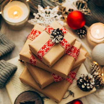 stack of christmas gifts, decorations and knitted sweater