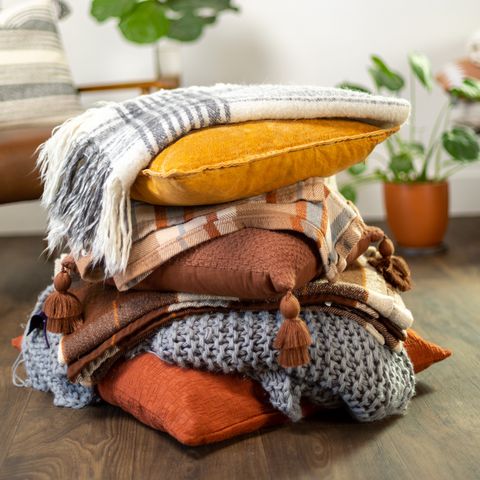 stack of fall pillows with blankets