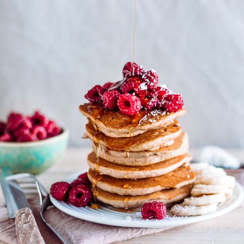 stack of raspberry and maple syrup pancakes