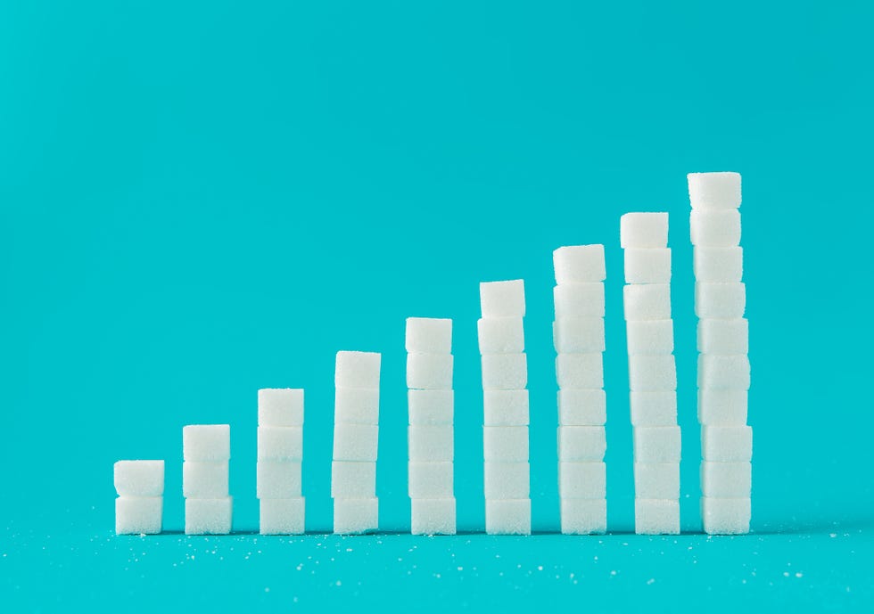 Stack Of Sugar Cubes Against Blue Background