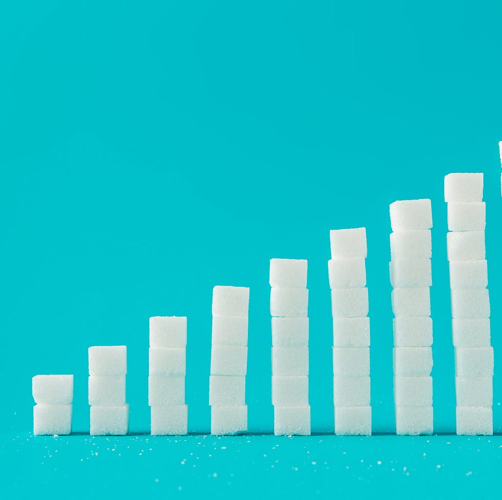 Stack Of Sugar Cubes Against Blue Background Stack Of Sugar Cubes Against Blue Background