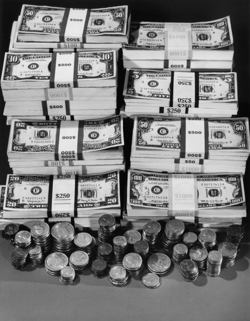 stacks of us paper currency and coins