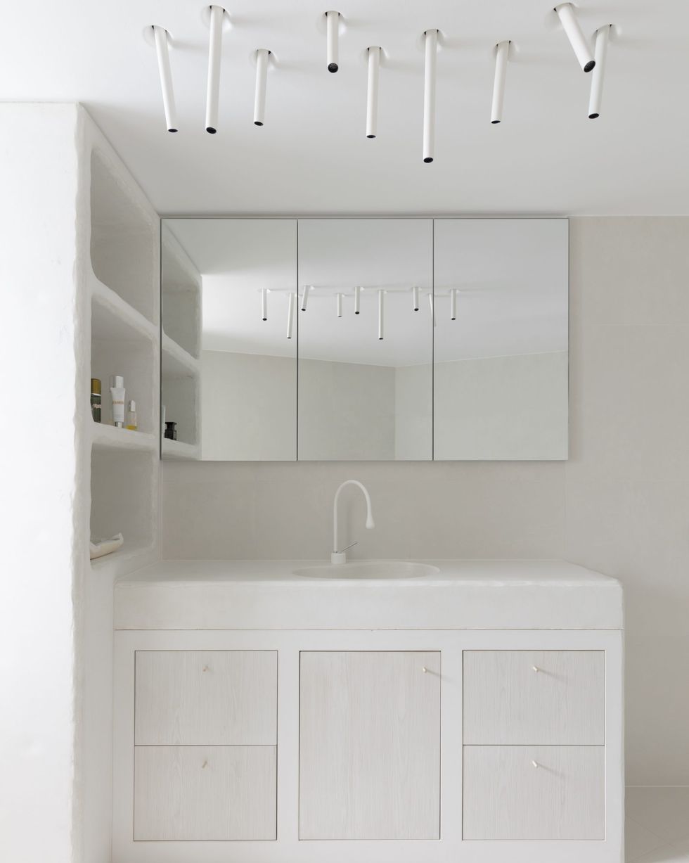 modern white bathroom with statement lighting