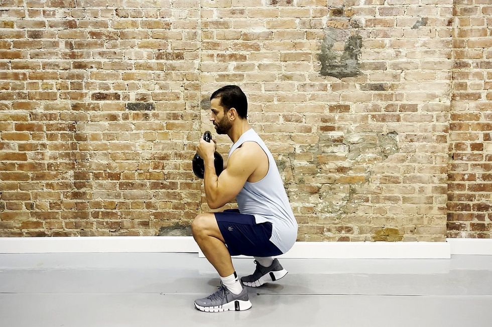 tamir practicing the staggered stance goblet squat exercise