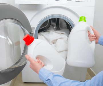 laundry setup with detergent bottles and washing machine