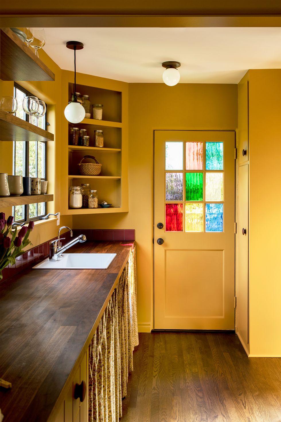 yellow kitchen with stained glass windows