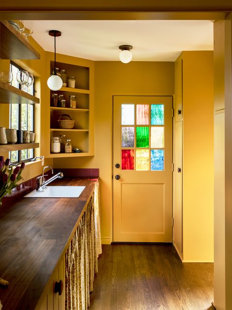 yellow kitchen with stained glass windows