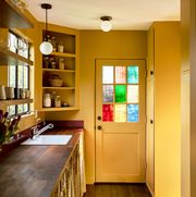 yellow kitchen with stained glass window