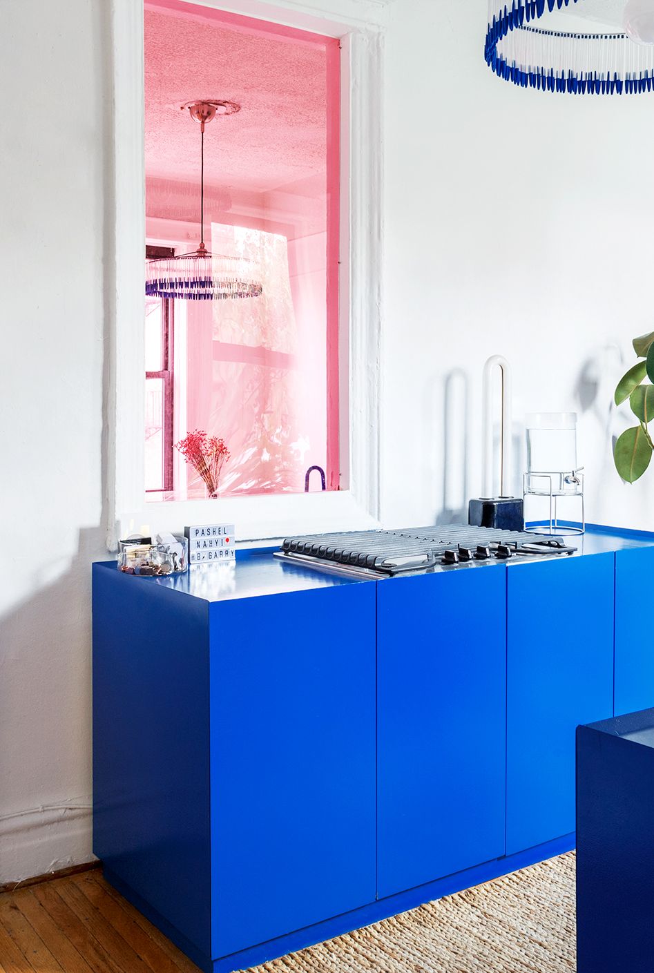 blue kitchen with pink interior glass window