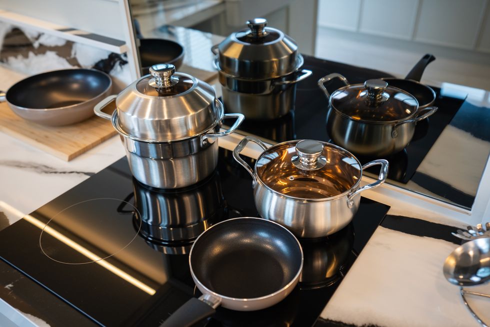 stainless steel cookware set on modern stovetop