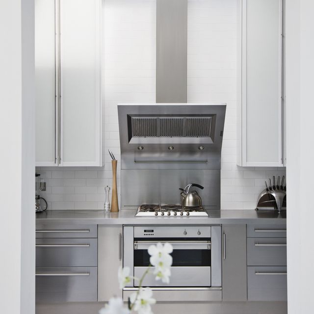 Stainless steel stove in modern white kitchen