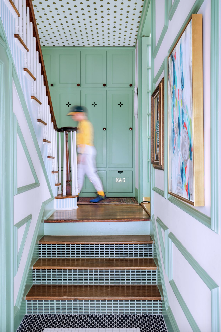 a person standing on mint green and white staircase