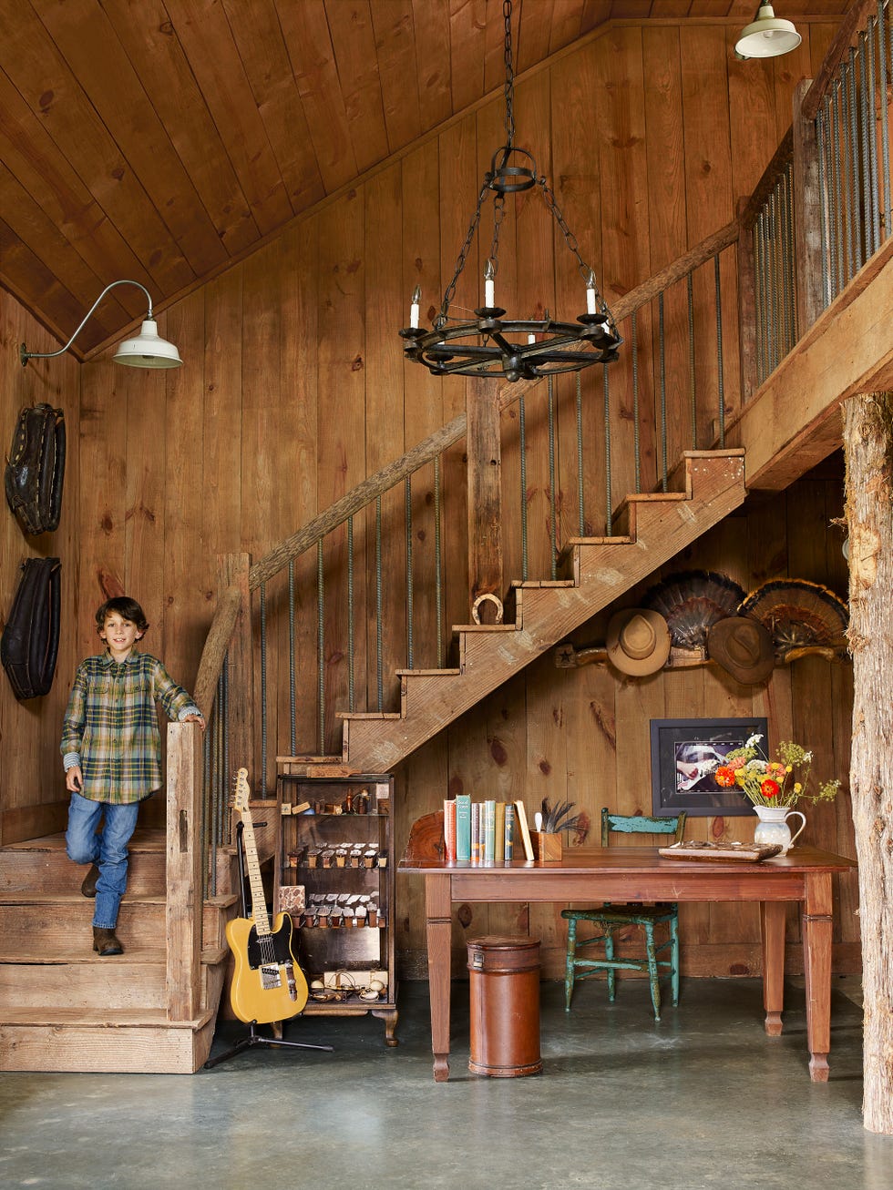 stained wooden staircase with desk underneath