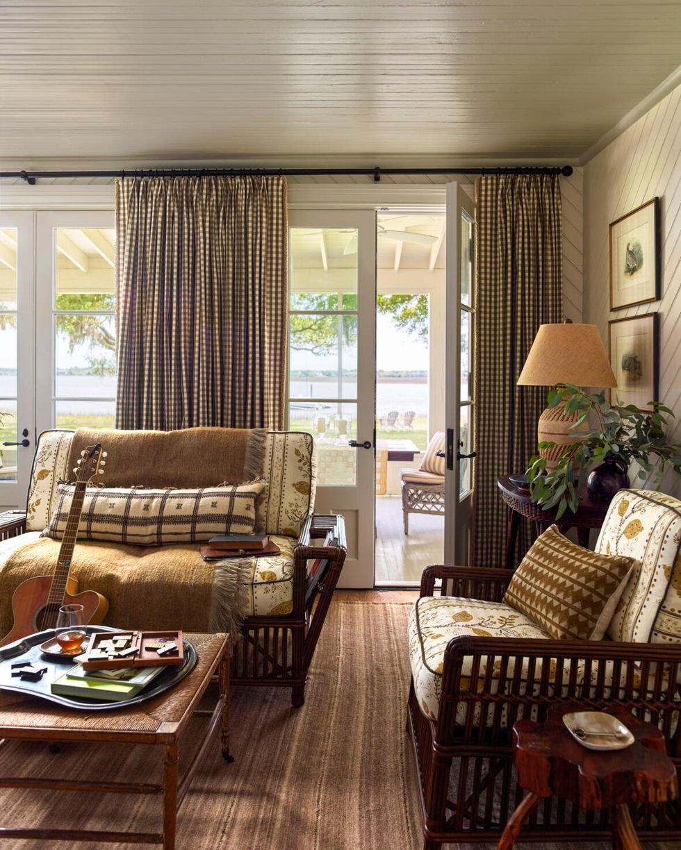 a living room with french doors to screened porch