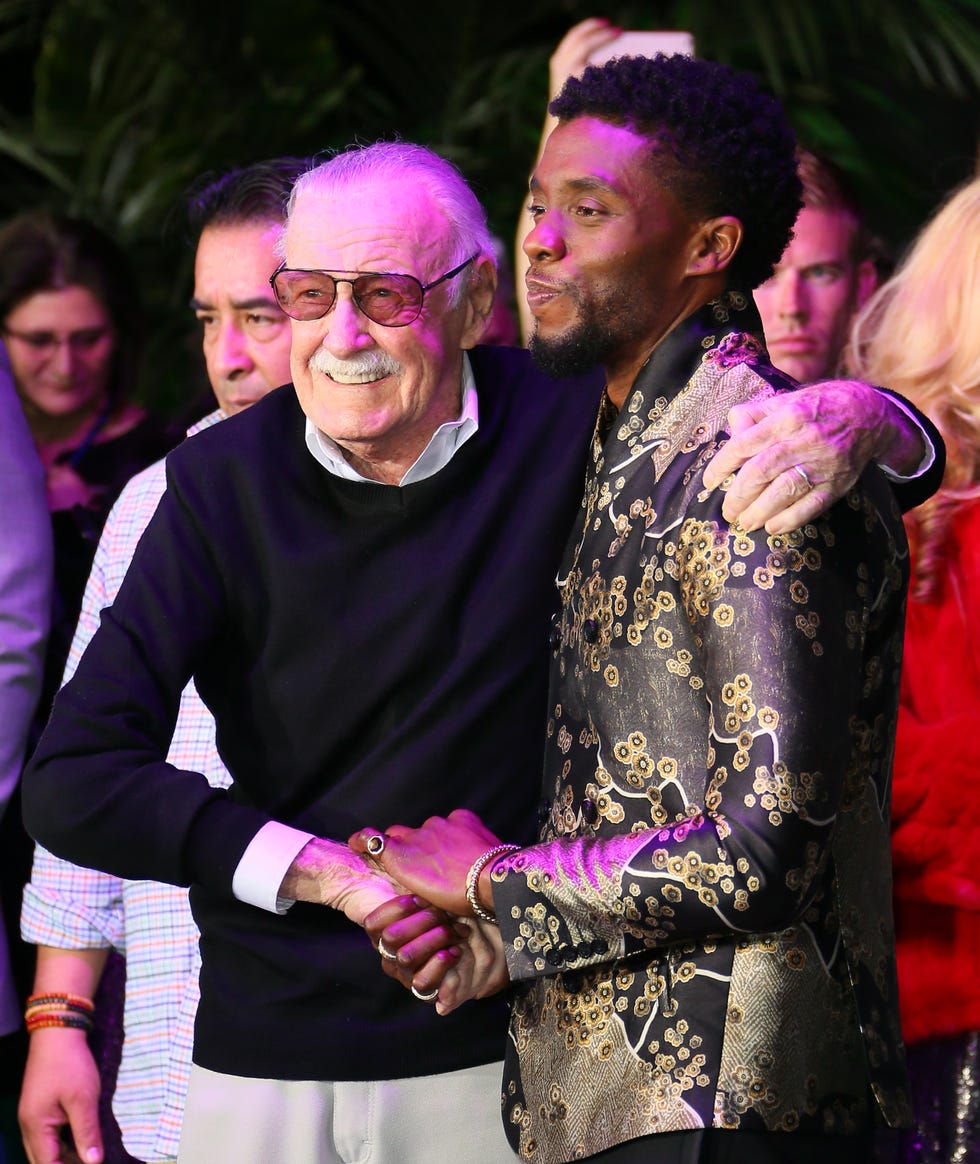 stan lee and chadwick boseman stand together for photos