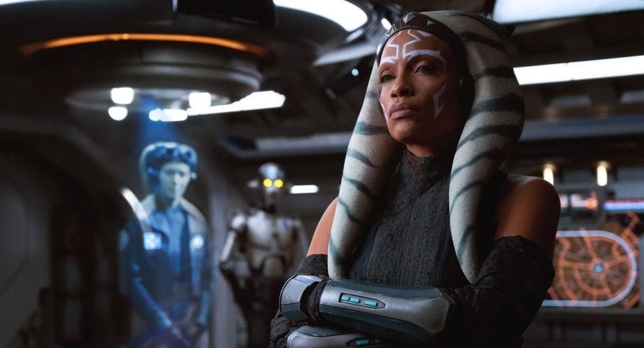 characters in a futuristic setting with a holographic display