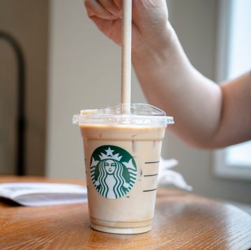 a customer is using a paper straw for a cold starbucks latte