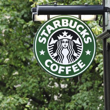 starbucks coffee sign hanging outside a shop